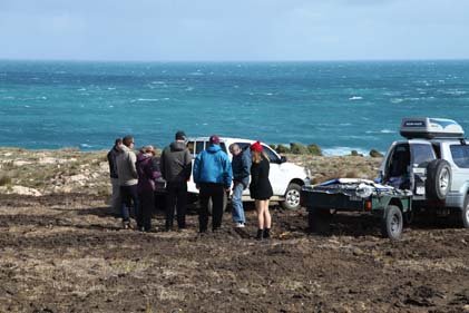 Cavers gathering at the cliff top above Starlight Cave. The mission was to count bats in the cave but the weather was brutal, and abseiling down the exposed cliff was not an option. Photo by Topaz Aral