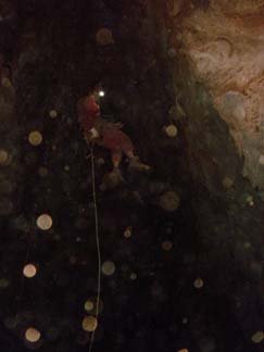 James Chitty (Son of David who runs AGA) abseiling into Dip Cave. Wee Jasper is generally a dry dusty caving area with only one wet cave. Note the amount of dust in the air. Photo by David Chitty.
